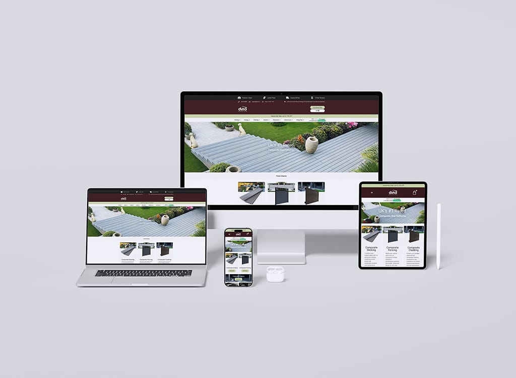 Image showcasing a responsive website design for a landscaping service displayed on multiple devices, including a desktop, laptop, tablet, and smartphone. The homepage features a scenic garden view with decorative elements and navigation options for concrete decking and fencing services.
