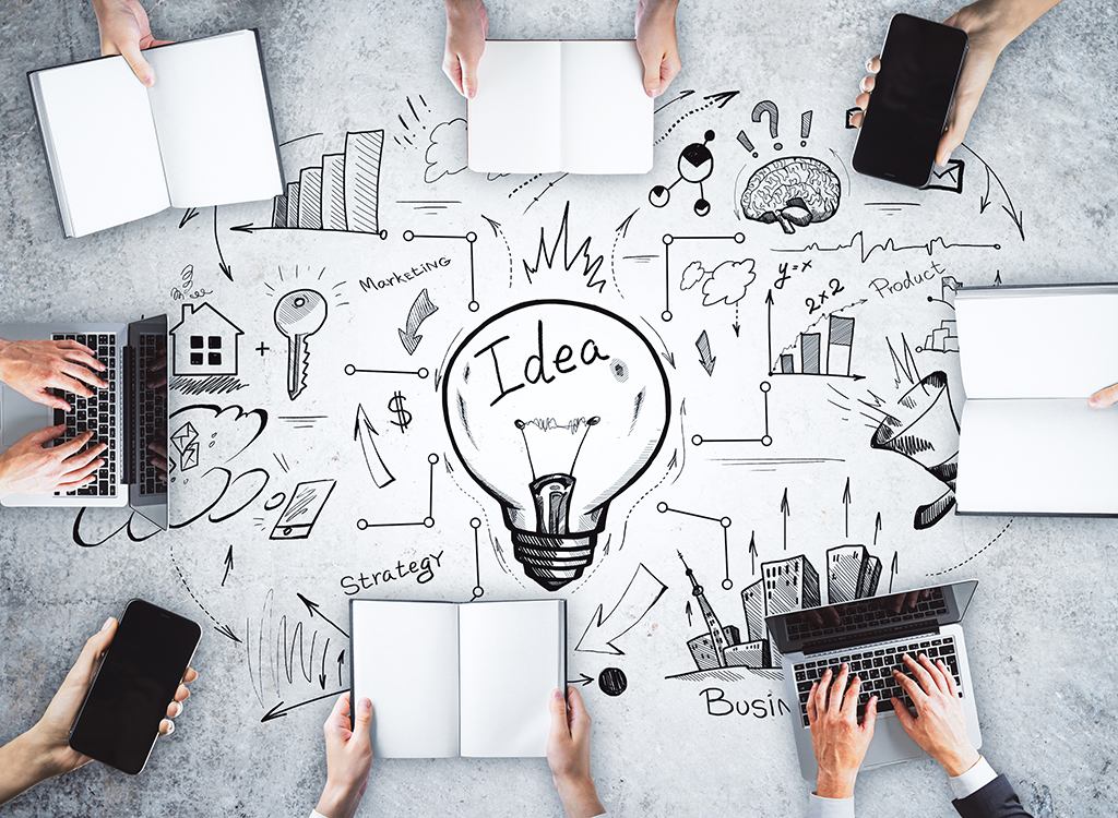 Group brainstorming session with notebooks and laptops, surrounded by creative doodles and diagrams illustrating concepts like ideas, business growth, and innovation.